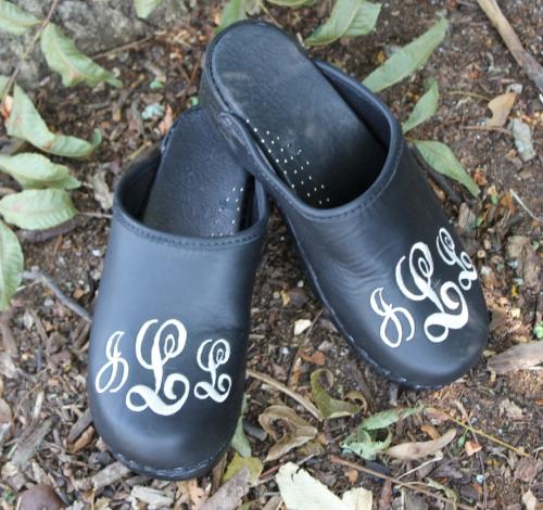 Black leather clog with a white sydney font monogram Black leather clogs with a sydney monogram NULL