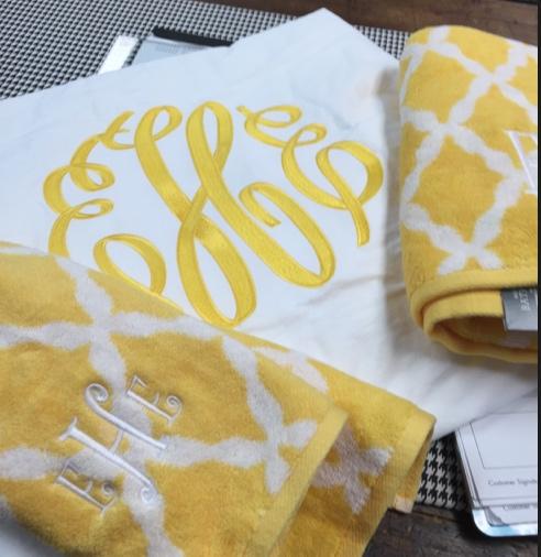 This is  large king coverlet with an interlocking yellow monogram with towels to match. So bright and pretty. Large yellow interlocking font with towels NULL